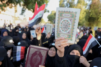 An image of a copy of the Quran during a protest in Baghdad, Iraq.